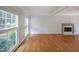 Spacious living room with hardwood floors, fireplace, and large windows at 5176 Shotwell St, Woodstock, GA 30188