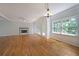 Open-concept living room with hardwood floors, fireplace, and access to outdoor patio at 5176 Shotwell St, Woodstock, GA 30188