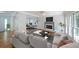 Cozy staged living room featuring wood floors, fireplace, stylish furniture, and natural light from windows at 5176 Shotwell St, Woodstock, GA 30188