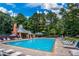Community pool with lounge chairs and umbrellas on a sunny day at 5176 Shotwell St, Woodstock, GA 30188