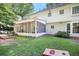 Expansive backyard view showcasing the screened porch, manicured lawn, and well-maintained exterior of the home at 7045 Hunters Ne Knl, Sandy Springs, GA 30328