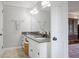 Bathroom with a granite countertop sink, mosaic flooring, and ample lighting at 7045 Hunters Ne Knl, Sandy Springs, GA 30328