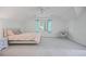 Light-filled bedroom with neutral walls, soft carpet, and a cozy sitting chair at 7045 Hunters Ne Knl, Sandy Springs, GA 30328