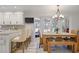 Open-concept kitchen and dining area boasts countertop seating and a cozy dining space with lots of light at 7045 Hunters Ne Knl, Sandy Springs, GA 30328