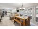 Bright dining area features wood table, a chandelier, and access to the outdoors through elegant glass doors at 7045 Hunters Ne Knl, Sandy Springs, GA 30328