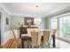 Elegant dining room with large windows, a chandelier, and a full dining set for six at 7045 Hunters Ne Knl, Sandy Springs, GA 30328