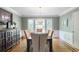 Well-lit dining room featuring hardwood floors, ample natural light, and a full dining set at 7045 Hunters Ne Knl, Sandy Springs, GA 30328