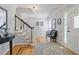 Bright foyer boasts hardwood floors, a staircase with black railing, and elegant decor at 7045 Hunters Ne Knl, Sandy Springs, GA 30328