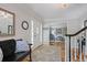 Spacious foyer with hardwood floors, decorative rug, bench and direct view into the living room at 7045 Hunters Ne Knl, Sandy Springs, GA 30328
