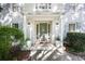 Inviting front porch features a neutral door, decorative plants, and stylish lighting fixtures at 7045 Hunters Ne Knl, Sandy Springs, GA 30328