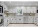 Bright, updated kitchen with white cabinets, stainless steel appliances, and subway tile backsplash at 7045 Hunters Ne Knl, Sandy Springs, GA 30328