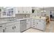 A kitchen featuring stainless steel appliances, white cabinets, and a seamless transition to the cozy dining area at 7045 Hunters Ne Knl, Sandy Springs, GA 30328