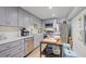 Modern kitchen with gray cabinets, stainless steel appliances, and a functional center island at 7045 Hunters Ne Knl, Sandy Springs, GA 30328