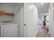 Efficient laundry area with modern washer and dryer setup and convenient storage shelves at 7045 Hunters Ne Knl, Sandy Springs, GA 30328