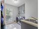 Functional laundry room boasts washer, dryer, sink, storage, and lots of natural light at 7045 Hunters Ne Knl, Sandy Springs, GA 30328