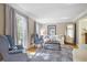 Cozy living room features large windows, hardwood floors, comfortable seating, and natural light at 7045 Hunters Ne Knl, Sandy Springs, GA 30328