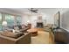 Comfortable living room features a fireplace, hardwood floors, large windows, and ample seating at 7045 Hunters Ne Knl, Sandy Springs, GA 30328