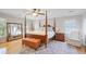 Spacious main bedroom features a four-poster bed, area rug, and hardwood floors at 7045 Hunters Ne Knl, Sandy Springs, GA 30328