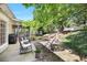 Inviting backyard with a stone patio, outdoor seating, and mature trees that offer shade and privacy at 7045 Hunters Ne Knl, Sandy Springs, GA 30328