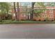 Traditional brick building featuring uniform windows and a well-maintained landscaped yard at 1166 Virginia Avenue Ne Ave # 8, Atlanta, GA 30306