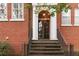 Charming brick building entrance with white columns and a beautiful glass and wood door at 1166 Virginia Avenue Ne Ave # 8, Atlanta, GA 30306