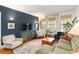 Living room with hardwood floors, a blue accent wall, and bright windows that bring nature indoors at 1166 Virginia Avenue Ne Ave # 8, Atlanta, GA 30306