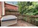 Private wooden patio offers built-in seating with storage underneath and a view of lush greenery at 1166 Virginia Avenue Ne Ave # 8, Atlanta, GA 30306
