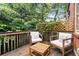 Cozy outdoor space with wooden patio, lush greenery, wooden table, and comfortable chairs at 1166 Virginia Avenue Ne Ave # 8, Atlanta, GA 30306