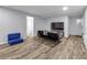 Finished basement living area with wood flooring and comfortable futon seating arrangement at 3402 Devoe Ct, Marietta, GA 30062