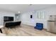 Finished basement area with seating, tv and a stainless steel refrigerator at 3402 Devoe Ct, Marietta, GA 30062