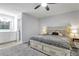 Bright bedroom featuring ensuite bath, ceiling fan, window, and large bed with side tables at 3402 Devoe Ct, Marietta, GA 30062