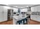 Renovated kitchen featuring stainless steel appliances, white cabinets, and stylish backsplash, perfect for cooking and entertaining at 3402 Devoe Ct, Marietta, GA 30062
