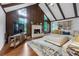Bright living room with a fireplace, wood beam vaulted ceilings, and large windows at 3402 Devoe Ct, Marietta, GA 30062
