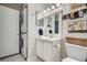 Bright bathroom with a large vanity, modern mirror, washer and dryer, and unique decor at 3655 Habersham Ne Rd # 344, Atlanta, GA 30305