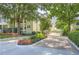 The Habersham of Buckhead entrance showcasing mature trees, beautiful landscaping, and a paved brick entrance road at 3655 Habersham Ne Rd # 344, Atlanta, GA 30305