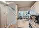 A kitchen with white cabinets, granite countertops, stainless appliances and a sink overlooking the living room at 3655 Habersham Ne Rd # 344, Atlanta, GA 30305