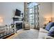 Cozy living room featuring fireplace, hardwood floors and large windows providing an abundance of natural light at 3655 Habersham Ne Rd # 344, Atlanta, GA 30305
