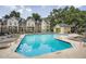 Community pool with lounge chairs and buildings surrounded by mature trees under sunny skies at 3655 Habersham Ne Rd # 344, Atlanta, GA 30305