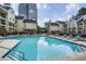 A clear swimming pool is surrounded by lounge chairs and features views of the community buildings at 3655 Habersham Ne Rd # 344, Atlanta, GA 30305