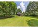 Picturesque backyard with a charming rustic shed nestled among mature trees at 434 Terrace Sw Dr, Smyrna, GA 30082