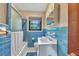 Small vintage bathroom with blue tile, shower-tub combination, and single sink vanity at 434 Terrace Sw Dr, Smyrna, GA 30082