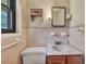 Small vintage bathroom with pink tile, single sink vanity, and natural light from window at 434 Terrace Sw Dr, Smyrna, GA 30082