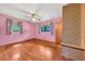 Bright pink bedroom with hardwood floors, ceiling fan, and windows providing natural light at 434 Terrace Sw Dr, Smyrna, GA 30082