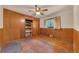 Bedroom with paneled walls, ceiling fan, small closet, and window with natural light at 434 Terrace Sw Dr, Smyrna, GA 30082