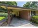 Attached carport featuring brick columns, a concrete floor, and access to the home at 434 Terrace Sw Dr, Smyrna, GA 30082