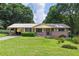 Charming single-story brick home featuring a manicured lawn and convenient carport at 434 Terrace Sw Dr, Smyrna, GA 30082
