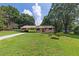 Traditional single-story home with a well-maintained lawn and lush, mature trees at 434 Terrace Sw Dr, Smyrna, GA 30082