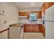 Galley style kitchen featuring vintage appliances, laminate countertops, and wooden cabinets at 434 Terrace Sw Dr, Smyrna, GA 30082