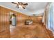 Open living space with hardwood floors, wood paneling, and an open view to the kitchen at 434 Terrace Sw Dr, Smyrna, GA 30082