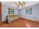 Bright living room with blue walls, ceiling fan, hardwood floors, and large couch at 434 Terrace Sw Dr, Smyrna, GA 30082